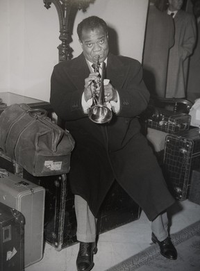 John McGinnis’ 1949 photo of Louis Armstrong playing his trumpet on his bags after being denied a room at the Hotel Vancouver because he was black.
