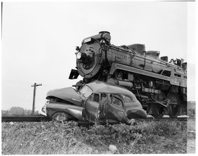 A John McGinnis photo of a grisly accident between a car and a train in the 1950s. Shots like this were a newspaper staple at the time.