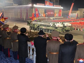 North Korean leader Kim Jong Un watches as missiles are displayed during a military parade to mark the 75th founding anniversary of North Korea's army, at Kim Il Sung Square in Pyongyang, North Korea Feb. 8, 2023, in this photo released by North Korea's Korean Central News Agency (KCNA).