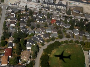 A WestJet 737-700 from Edmonton casts a shadow as the plane makes its final descent for landing at the Vancouver International Airport in Richmond.