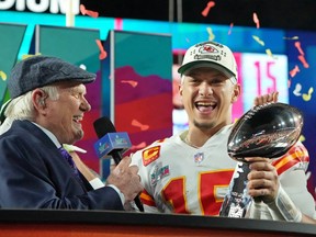 Kansas City Chiefs quarterback Patrick Mahomes is all smiles, holding the Vince Lombardi Trophy while being interviewed by Fox Sports analyst Terry Bradshaw after the Chiefs won the Super Bowl 38-35 over the Philadelphia Eagles in Glendale, Ariz., last Sunday.