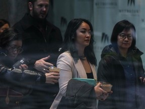 Jennifer Chan (front centre), the sister of late Vancouver Police Const. Nicole Chan, who died by suicide in 2019, at the coroner's inquest, in Burnaby on Jan. 23, 2023.