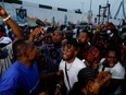 People cheer after poll workers announced results, at their polling unit in Awka, Anambra state, Nigeria February 25, 2023. REUTERS/Temilade Adelaja