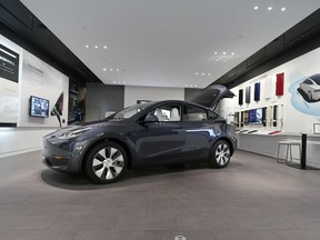 FILE - A Tesla Model Y Long Range is displayed on Feb. 24, 2021, at the Tesla Gallery in Troy, Mich. Tesla has raised prices on its Model Y in the U.S., apparently due to rising demand and changes in U.S. government rules that make more versions of the small SUV eligible for tax credits.
