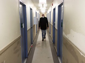 Dr. Bill MacEwan, a psychiatrist and leading researcher into housing and mental illness, walks the halls of an SRO apartment block in the Downtown Eastside on Feb. 2, 2023.
