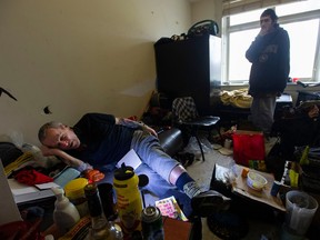 SRO resident John Wittenberg (left) in his room in the Downtown Eastside on Feb. 2, 2023.