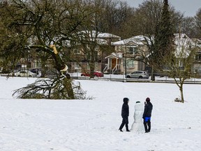 Kids build a snowman after a late-season snowfall hit Vancouver on Feb. 28, 2023.