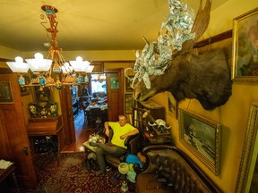 Robert McNutt in his unique antique-filled apartment in Vancouver.