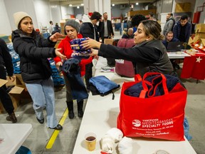 Volunteers sort and pack items donated to victims of the earthquake in Turkey and Syria inside a warehouse in Vancouver.