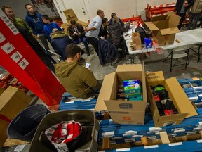 Volunteers organize and sort items donated for victims of the earthquake in Turkey inside a warehouse in Vancouver on Monday.