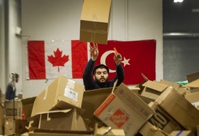 A volunteers in Vancouver helps pack donations for survivors of the earthquake that devastated parts of Turkey and Syria on Monday.