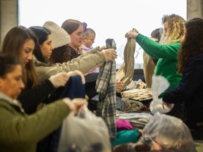 Volunteers in Vancouver sort and pack clothing donations for survivors of the earthquake that devastated parts of Turkey and Syria on Monday.