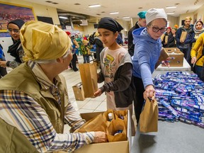 Volunteers prepare care packages for women's shelters on Monday, Family Day.