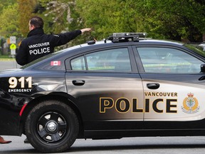 File photo of a Vancouver police officer and vehicle at a scene.