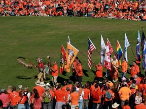 The grand entry takes place during the South Island powwow on National Truth and Reconciliation Day at Royal Athletic Park hosted by the Songhees Nation in Victoria, B.C., on Friday, September 30, 2022. The British Columbia government has introduced legislation to make Sept. 30 a National Day for Truth and Reconciliation Day a paid statutory holiday.