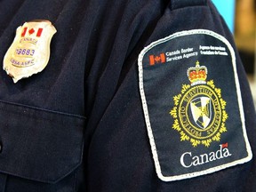 A Canadian Border Services Agency (CBSA) officer's shoulder flash is shown at the Calgary Courts Centre on April 22, 2017.