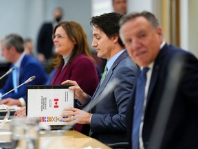 Prime Minister Justin Trudeau, flanked by Manitoba Premier Heather Stefanson (left) and Quebec Premier Francois Legault (right), at first ministers meeting on health care in Ottawa last week. Governments need to do more in support of health workers, says Ivy Lynn Bourgeault of the Canadian Health Workforce Network.