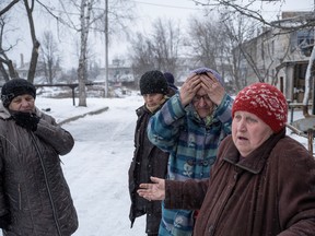 People stand in front of their shelter, amid Russia's attack on Ukraine, in Siversk, Donetsk region, Ukraine, February 18, 2023. REUTERS/Marko Djurica