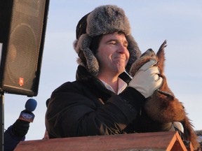 Handler Roberto Blondin with Fred la Marmotte. Groundhogs have "very sensitive hearing,” PETA says, and "these events are both terrifying and stressful" for them.