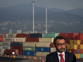 Minister of Transport Omar Alghabra listens during an announcement at Port Metro Vancouver's Centerm container terminal, in Vancouver, B.C., Friday, Oct. 14, 2022. Four federal Liberal MPs have written to Alghabra expressing frustration with a much-criticized program that aims to replace older trucks that service the Vancouver Port Authority.