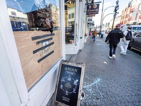 The window at Anian on Johnson Street was boarded up on Friday, after a spate of vandalism in downtown Victoria.
