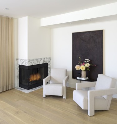 wood burning fireplace and two easy chairs