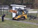 A tracked skid-steer loader sits on a residential street in Duncan on Wednesday, March 29, 2023. 