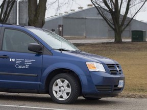 A Canadian Food Inspection Agency van on scene at an Ontario farm infected with a new strain of bird flu.