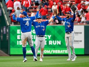 George Springer, Kevin Kiermaier and Daulton Varsho of the Toronto Blue Jays celebrate their teams 10-9 victory over the St. Louis Cardinals on Opening Day at Busch Stadium on March 30, 2023 in St Louis, Missouri. Photo: Joe Puetz/Getty Images