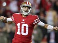 Jimmy Garoppolo of the San Francisco 49ers celebrates after a touchdown by Christian McCaffrey during the fourth quarter against the Los Angeles Chargers at Levi's Stadium on November 13, 2022 in Santa Clara, California.