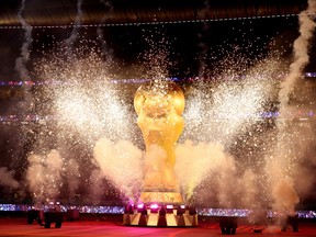 Pyrotechnics explode around a giant FIFA World Cup trophy before the semifinal between France and Morocco at Al Bayt Stadium in Al Khor, Qatar, on Dec. 14, 2022