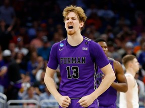 Garrett Hien of the Furman Paladins celebrates after scoring against the Virginia Cavaliers during the second half in the first round of the NCAA Men's Basketball Tournament at Amway Center on March 16, 2023 in Orlando, Florida. Photo: Kevin Sabitus/Getty Images
