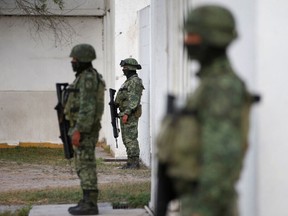 Soldiers stand guard outside the Forensic Medical Service morgue building ahead of the transfer of the bodies of two of four Americans kidnapped by gunmen to the U.S. border, in Matamoros, Mexico, March 9, 2023.