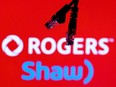 Ethernet cables are seen in front of Rogers and Shaw Communications logos in this illustration taken, July 8, 2022.