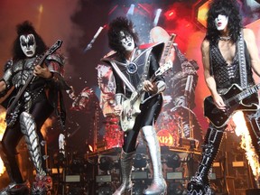 KISS’s Gene Simmons (left), Tommy Thayer (centre) and Paul Stanley (right) perform at the Movistar Arena in Bogota on May 7, 2022. (Photo by Juan Pablo Pino/AFP)