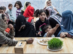 Afghan customers wait for their food to be served at a restaurant named Banowan-e- Afghan that employs female staff in Kabul on March 16, 2023. (Photo by Wakil KOHSAR / AFP)