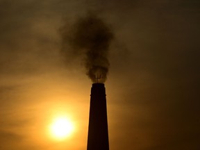 In this photo taken on March 15, 2023, smoke billows from a brick factory chimney on the outskirts of Prayagraj. UN Secretary General Antonio Guterres called on wealthy countries on March 20, 2023, to move up their goals of achieving carbon neutrality as close as possible to 2040, mostly from 2050 now, in order to "defuse the climate time bomb."