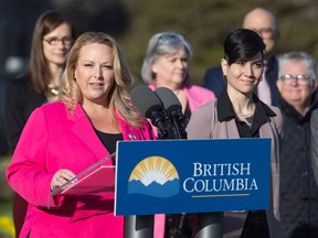 B.C. government staff raise the transgender flag at the legislature on Thursday, March 30.