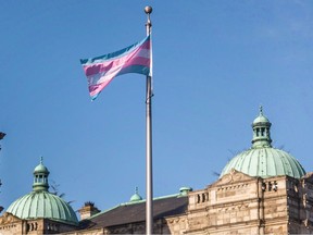 B.C. government staff raise the transgender flag at the legislature on Thursday, March 30.