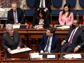 B.C. Finance MInister Katrine Conroy, left, introduces her first budget in the legislative assembly at legislature in Victoria, on Tuesday, Feb. 28, 2023. Premier David Eby watches from beside her.