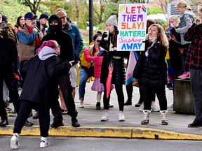 A protester yells at a counter-protester holding a sign prior to a Drag Queen Story Time at the Coquitlam City Centre library in Coquitlam on Jan. 14, 2023.