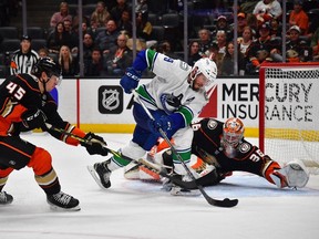 Canucks centre J.T. Miller (9) moves in for a shot against Anaheim Ducks goaltender John Gibson (36) as defenceman Colton White (45) helps defend during the third period at Honda Center.
