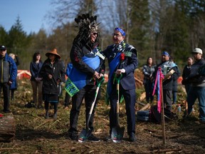 Kelsey Charlie (Tixweltel), left, an elected councillor with the Sts'ailes First Nation, talks with B.C. Health Minister Adrian Dix, during a groundbreaking and traditional ceremony for a new Sts'ailes primary healthcare facility, in Harrison Mills, B.C., on Friday, March 17, 2023. The Sts'ailes Community Care Campus will be owned and operated by the First Nation.