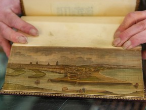 Richard Smart is a third-generation book binder. He is holding a fore-edge painting on a book from the 1800s.