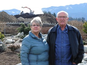 Judy and Dennis Morelli in front of a pile of steaming composted manure. Neighbours want the Abbotsford composting facility to meet provincial regulations.