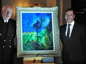 Michael Audain, left, and Audain Art Museum director Curtis Collins unveil the Emily Carr painting Survivor at the Vancouver Club March 15, 2023.