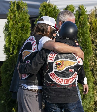 Member of the Hells Angels greet each other out front of the Nanaimo Hells Angels' clubhouse in Nanaimo, BC, July, 20, 2018.