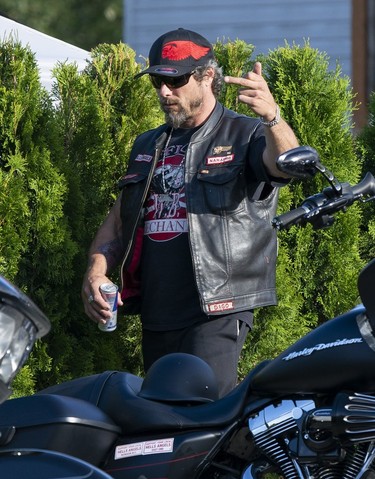 Member of the Hells Angels welcomes the police and media out front of the Nanaimo Hells Angels' clubhouse in Nanaimo, BC, July, 20, 2018.