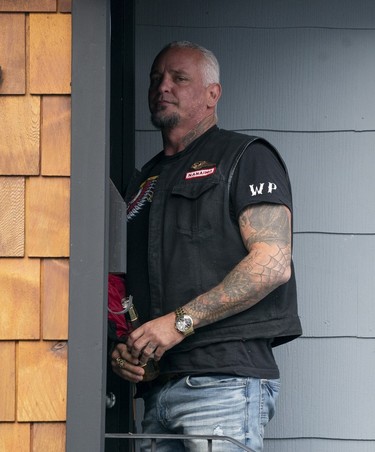 Member of the Hells Angels goes into the Nanaimo Hells Angels' clubhouse in Nanaimo, BC, July, 20, 2018.
