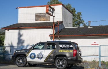 A vehicle belonging to The Combined Forces Special Enforcement Unit of British Columbia sits in front of the former Nanaimo Hells Angels clubhouse in Nanaimo, BC, July, 20, 2018.